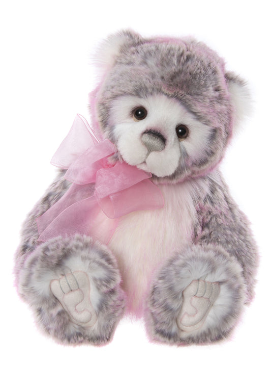 Pink plush bear from Charlie Bear with white face and bow